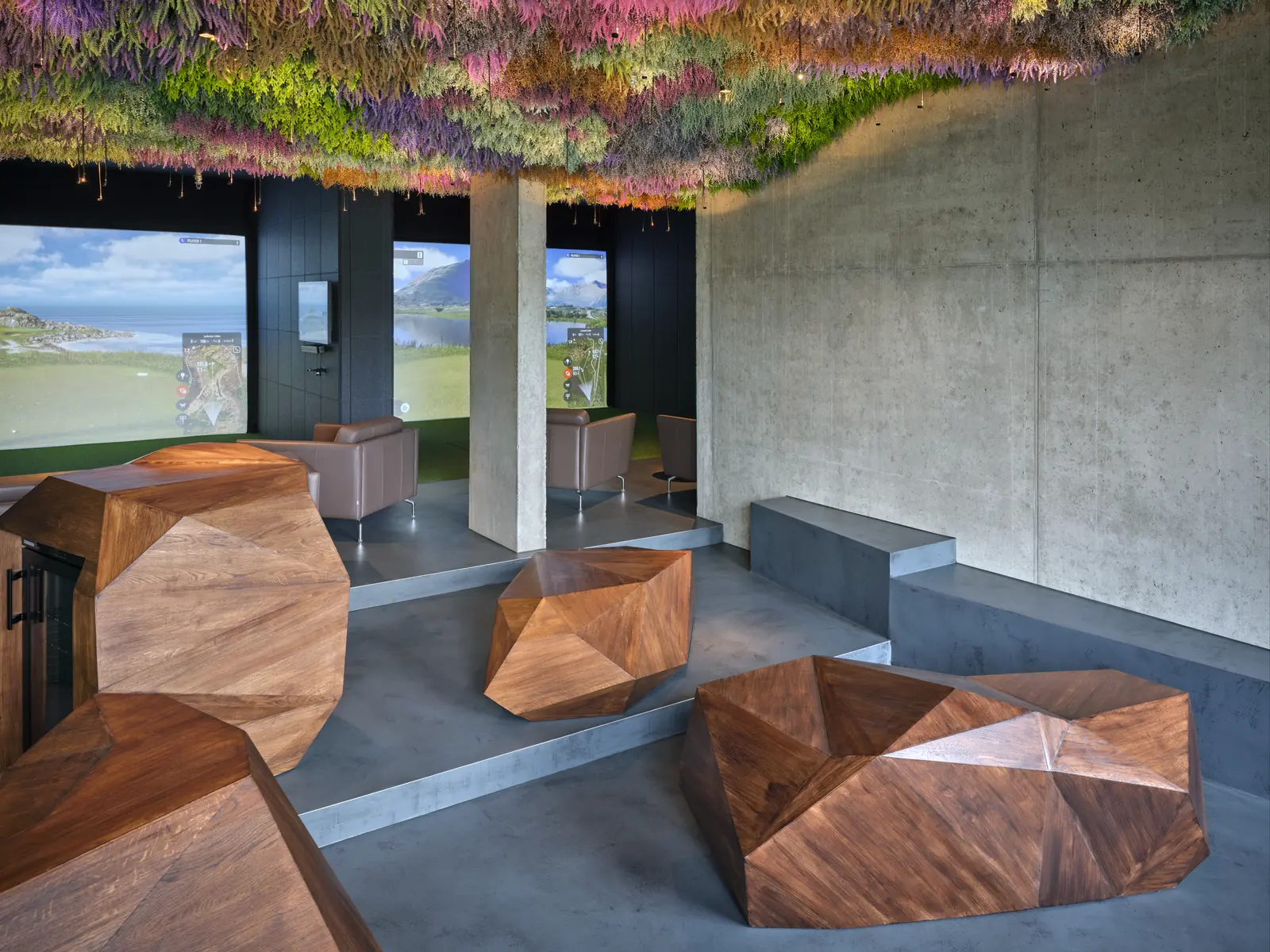 The Mulligan lounge with wooden seats and two screens